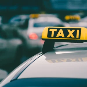 selective-focus-shot-yellow-taxi-sign-traffic-jam